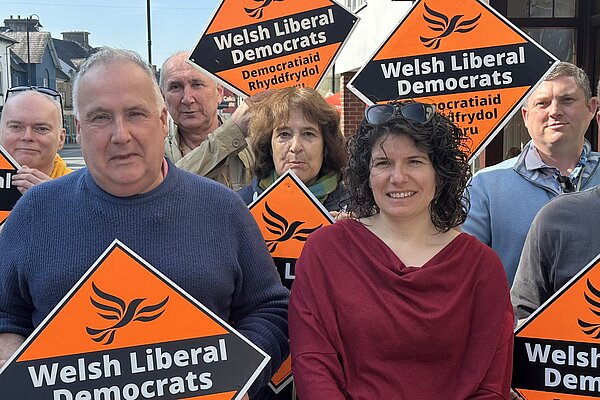 Sandra Jervis with a group of supporters holding Lib Dem diamond signs